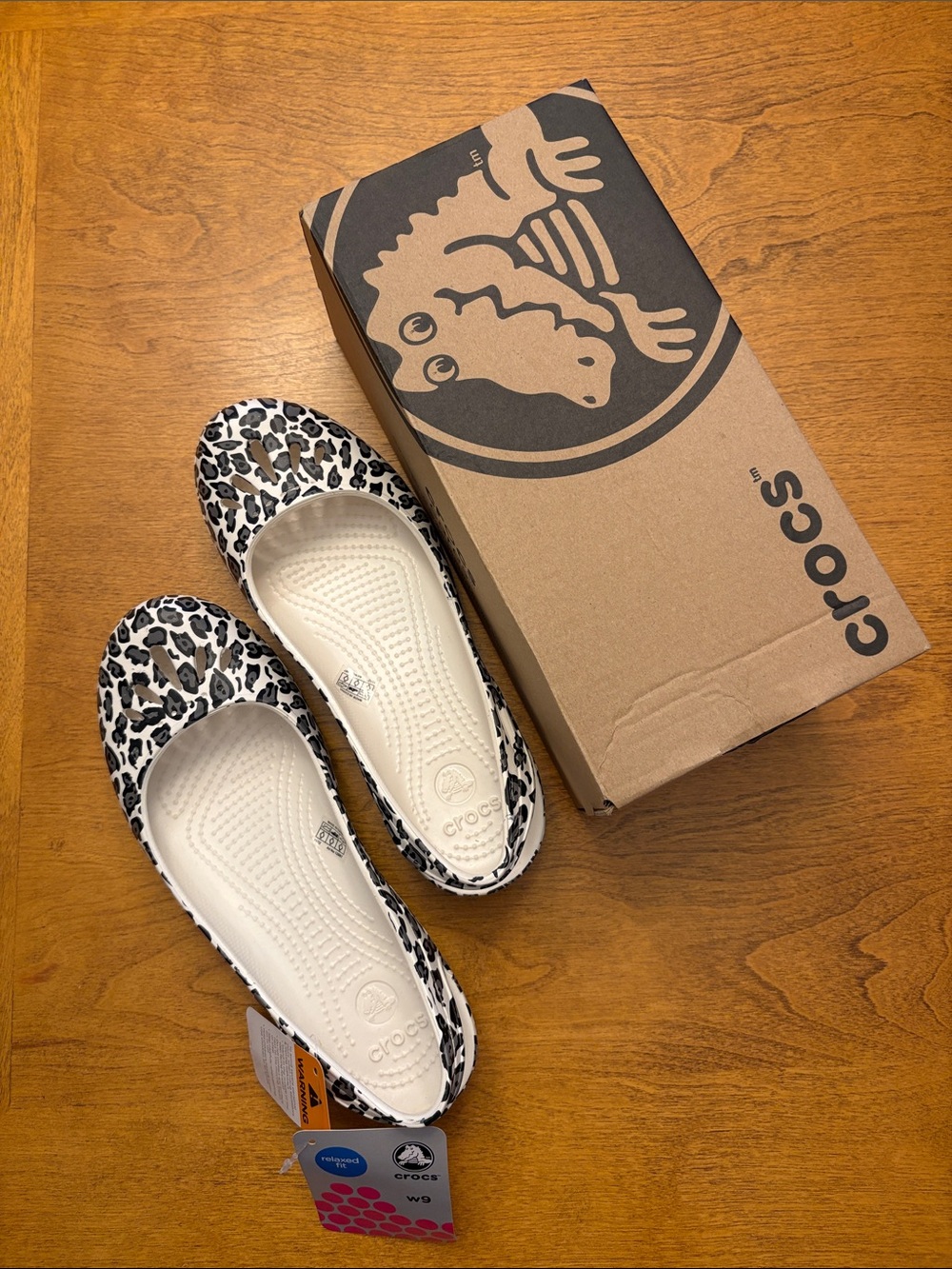 CROCS women’s Leopard-Print Slip-On Flats in White and Black